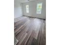 Spacious bedroom with new flooring and two windows offering natural light at 6662 Witherington Ct, Norcross, GA 30093