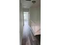 Upstairs hallway with neutral paint, nice flooring and white railing at 6662 Witherington Ct, Norcross, GA 30093