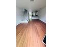 Open-concept living room with hardwood floors leading to the kitchen and staircase at 6662 Witherington Ct, Norcross, GA 30093