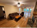 Bright living room featuring hardwood floors, a stone fireplace, and abundant natural light from large windows at 3054 Whisper Knob Rd, Marietta, GA 30062