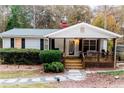 Well-maintained single-story home with a covered front porch and stone walkway at 307 Little Hickory Ln, Woodstock, GA 30189
