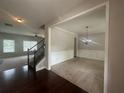 Open-concept living area featuring carpeted floors and a chandelier at 443 Strawberry Walk, Loganville, GA 30052
