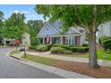 Charming home with blue siding, manicured landscaping, and a welcoming front porch at 400 Pringle Dr, Suwanee, GA 30024