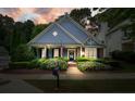 Charming home with blue siding, manicured landscaping, and a welcoming front porch at 400 Pringle Dr, Suwanee, GA 30024