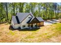 Aerial view of a white two story home featuring black trim, covered parking and a private yard at 90 Ayers Rd, Bowdon, GA 30108