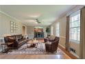 Inviting living room with hardwood floors, a brick fireplace, and plenty of natural light at 1744 Cum Laude Way, Lawrenceville, GA 30044