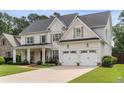 Charming two-story home with a well-kept lawn, an attached two-car garage, and classic architectural details at 1860 Leighton Ln, Marietta, GA 30062