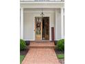 Welcoming front entrance features a double-door entry with brick steps and decorative plants, adding charm and curb appeal at 1860 Leighton Ln, Marietta, GA 30062