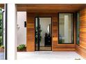 Exterior entrance featuring natural wood accents, modern tiling, and black trimmed windows at 16 Bonnie Ln, Atlanta, GA 30328