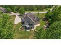 Charming two-story home with mature trees, a screened porch, and a well-maintained landscaped yard at 893 Somersby Dr, Dallas, GA 30157