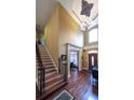 Elegant foyer with soaring ceilings, a grand chandelier, hardwood floors, and staircase with iron railing at 893 Somersby Dr, Dallas, GA 30157