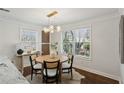 A stylish dining room with modern light fixture and views of the landscaped backyard at 1833 Flat Shoals Se Rd, Atlanta, GA 30316