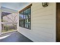 A cozy front porch featuring a light blue ceiling, white siding, and dark framed windows at 1833 Flat Shoals Se Rd, Atlanta, GA 30316