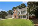 Attractive two-story home with landscaped lawn, attached garage, and brick and siding exterior details at 228 Kensington Trce, Stockbridge, GA 30281