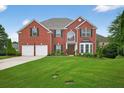 Charming two-story brick home with a lush green lawn, complemented by mature trees at 4203 Norbury Ct, Smyrna, GA 30080