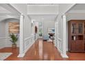 Elegant foyer showcasing hardwood floors, decorative columns, and an open view to the living area at 4203 Norbury Ct, Smyrna, GA 30080
