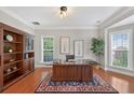 Bright office featuring hardwood floors, built-in bookshelves, and a spacious desk at 4203 Norbury Ct, Smyrna, GA 30080