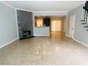 Bright living room with tile floors, fireplace with stone accent wall, and open concept to the kitchen at 4645 Valais Ct # 10, Johns Creek, GA 30022