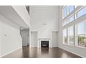 Spacious living room with soaring ceilings, fireplace, and plenty of natural light at 5575 Mirror Lake Dr, Cumming, GA 30028