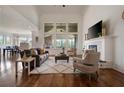 Bright living room boasts hardwood floors, fireplace, tall windows, and an open floor plan at 5915 Read Rd, Suwanee, GA 30024
