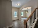 Open-concept home featuring stylish floors, arched doorways, and elegant chandelier lighting at 68 Jeffrey Ln, Dallas, GA 30157