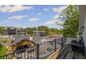 Relax on the balcony overlooking the pool and outdoor kitchen at 8175 Main St, Woodstock, GA 30188