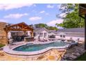 Stunning pool area with an outdoor kitchen at 8175 Main St, Woodstock, GA 30188