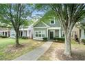 Two story home with shaker siding and covered porch with sidewalk leading to front door at 126 Wellbrook Ne Ct, Conyers, GA 30012