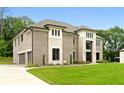 Gorgeous two-story home featuring a three-car garage, brick facade, and lush green lawn at 3012 Flat Shoals Rd, Conyers, GA 30094