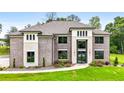 Beautiful brick home featuring an inviting front lawn with vibrant flower beds and a stylish entrance at 3012 Flat Shoals Rd, Conyers, GA 30094