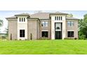 Charming brick home featuring a well-manicured lawn and a modern front door at 3012 Flat Shoals Rd, Conyers, GA 30094