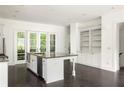 Bright kitchen with a granite island and stainless steel appliances at 9071 Selborne Ln, Chattahoochee Hills, GA 30268