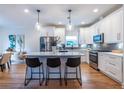 Modern kitchen featuring white cabinets, stainless steel appliances, and a center island with bar stool seating at 1542 Idlewood Rd, Tucker, GA 30084