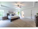 Spacious main bedroom with a tray ceiling, ceiling fan, and lots of natural light at 1542 Idlewood Rd, Tucker, GA 30084