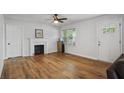 Bright living room features hardwood floors, a fireplace, and a window for natural light at 3006 Dogwood Dr, Hapeville, GA 30354
