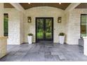 Home entrance featuring black framed glass doors, stone floors, and lantern style lighting at 306 Pinecrest Ne Rd, Atlanta, GA 30342