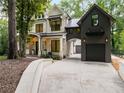 Two-story house featuring a driveway that leads to a garage and exterior stone facade at 306 Pinecrest Ne Rd, Atlanta, GA 30342
