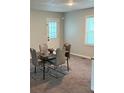 Cozy dining area featuring a modern table and chairs and a view to the backyard at 3990 N Quail Dr, Douglasville, GA 30135