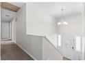 Bright entryway featuring white walls, chandelier, and a front door with decorative glass accents at 3990 N Quail Dr, Douglasville, GA 30135