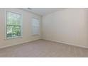 Bedroom featuring neutral carpet, two windows, and a blank canvas for your personal touch at 808 Plaintain Dr, Woodstock, GA 30188