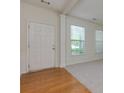 Entryway featuring hardwood floors with views into the living room and large windows at 808 Plaintain Dr, Woodstock, GA 30188