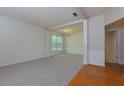 Spacious living room with plush carpet, columns, large windows and a view into the dining area at 808 Plaintain Dr, Woodstock, GA 30188