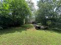 Overgrown backyard with potential for landscaping and customization, surrounded by lush trees at 861 Marion Se Ave, Atlanta, GA 30312