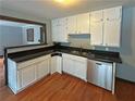 Well-appointed kitchen with stainless steel dishwasher, black countertops, and white cabinetry offering style and functionality at 861 Marion Se Ave, Atlanta, GA 30312