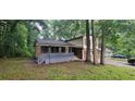 View of the home's side, showcasing the brick details and covered porch at 2035 Northland Dr, Lawrenceville, GA 30044