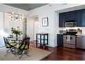 Dining area featuring a modern chandelier and seating for four at 620 Glen Iris Dr # 223, Atlanta, GA 30308
