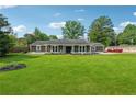 Expansive front yard view of a single-story house with lush green grass and mature trees at 3280 Pebble Hill Dr, Marietta, GA 30062
