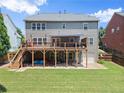 Two-story home featuring a spacious wooden deck with a covered patio area below, perfect for outdoor entertaining at 4665 Idlewood Dr, Cumming, GA 30040