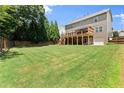 Expansive, well-maintained backyard with a large deck and patio, ideal for outdoor activities and relaxation at 4665 Idlewood Dr, Cumming, GA 30040