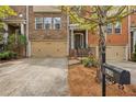 Charming brick townhome with a two-car garage, landscaping, and a welcoming front entrance at 630 Birch River Ln, Lawrenceville, GA 30043